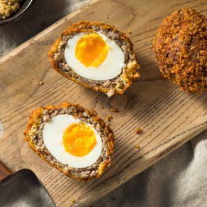 Halved Scotch egg with runny yolk