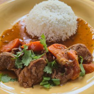 Savory beef dish with fresh herbs and rice.