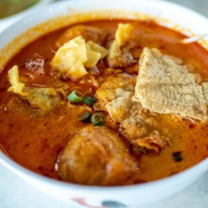 Bowl of curry noodles with crispy garnish