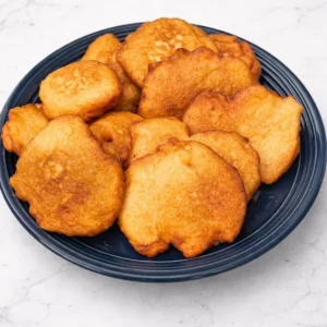 Plate of golden brown fried fritters.
